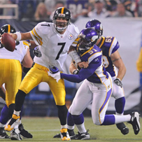 Ben is grabbed by the Minnesota Vikings' Ray Edwards in the first quarter at the Metrodome, Aug. 23, 2008.
